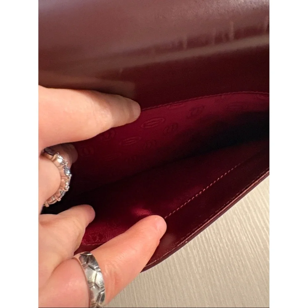 Cartier Burgundy Leather wristlet with Gold Corners